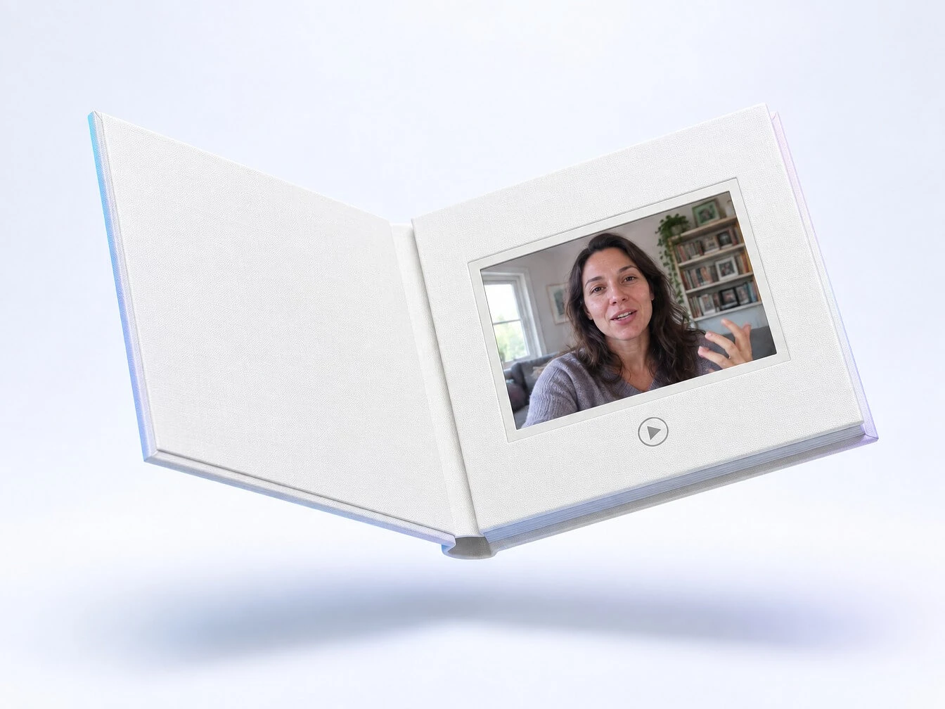 An open Tribute Video Book, a linen hardcover with a built-in screen playing a video message